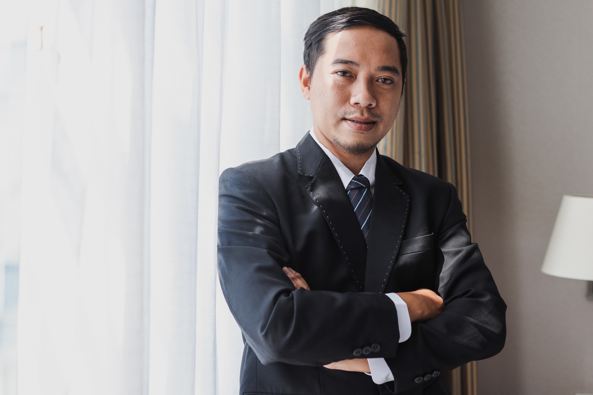 Confident asian business man with black suit