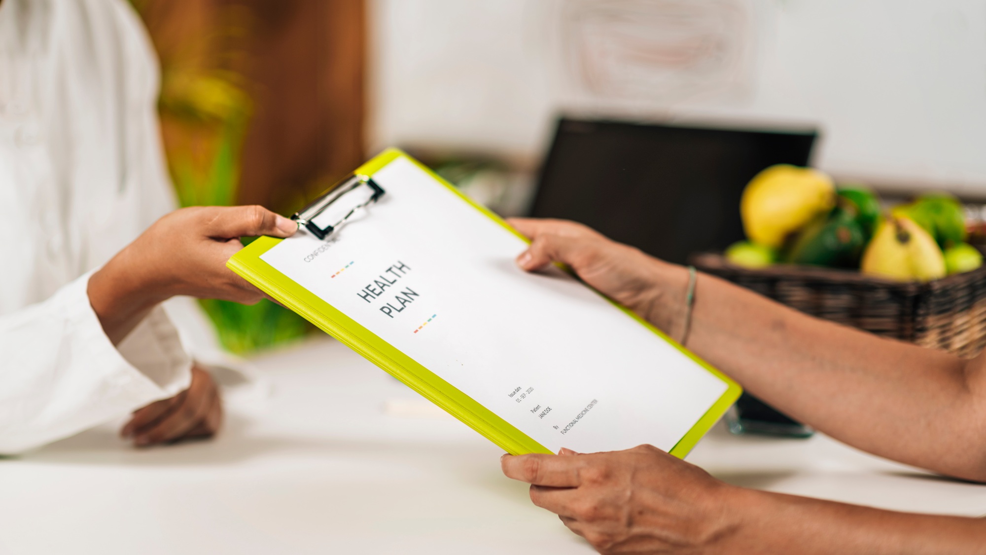 Preventive Healthcare Professional Handing a Personalized Health Plan to a Client